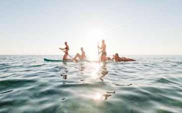 sunset stand up paddleboarding