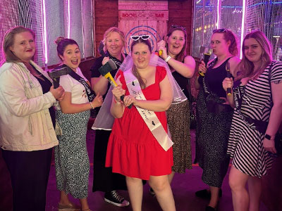 A group of hens doing axe throwing in Bath.