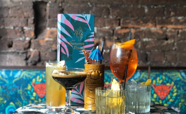 a table set with cocktails and the common room's menu