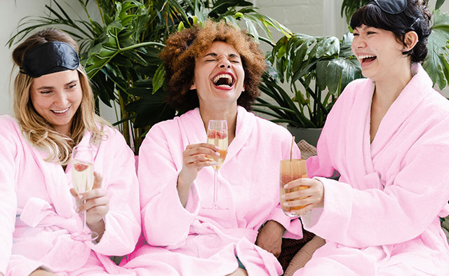 Three women having a pink pamper party 