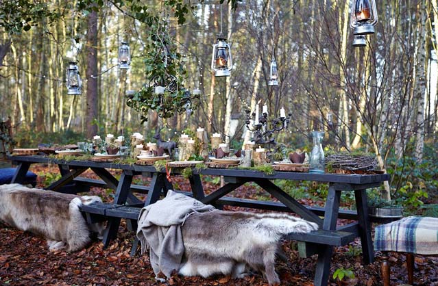 Outdoor woodland dining setup with rustic benches and lanterns at Yorkshire Glamping hen party site.