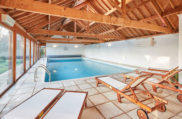 Indoor swimming pool with loungers at Moors Manor, a luxury North Yorkshire hen party house.