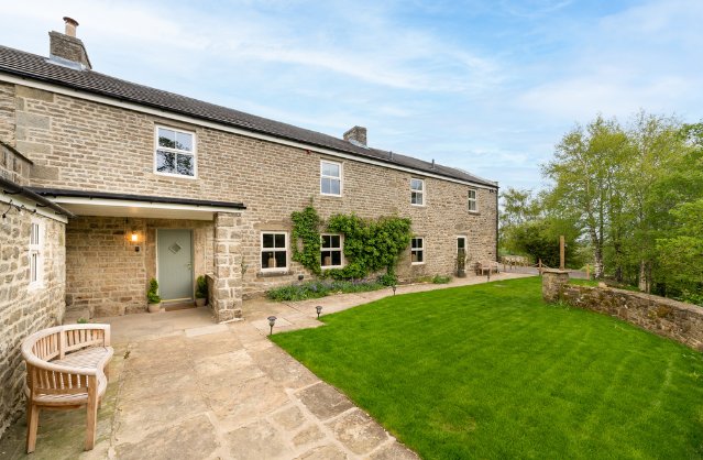Front exterior and garden of Pennines Manor, a luxury countryside hen party house in the North Pennines.