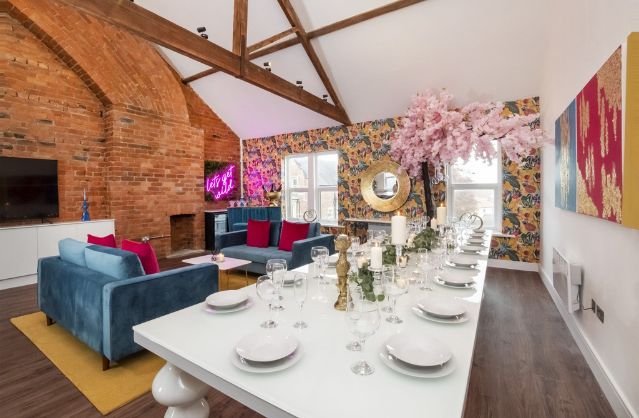 Modern open-plan living and dining area with bold décor at Fishergate House, a stylish York hen party property.